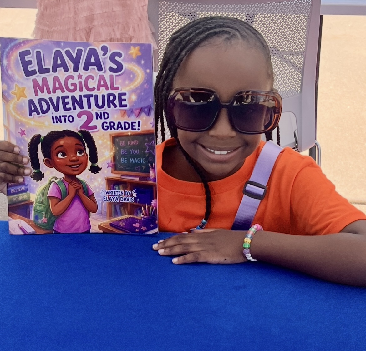 Elaya sharing her second-grade adventure book