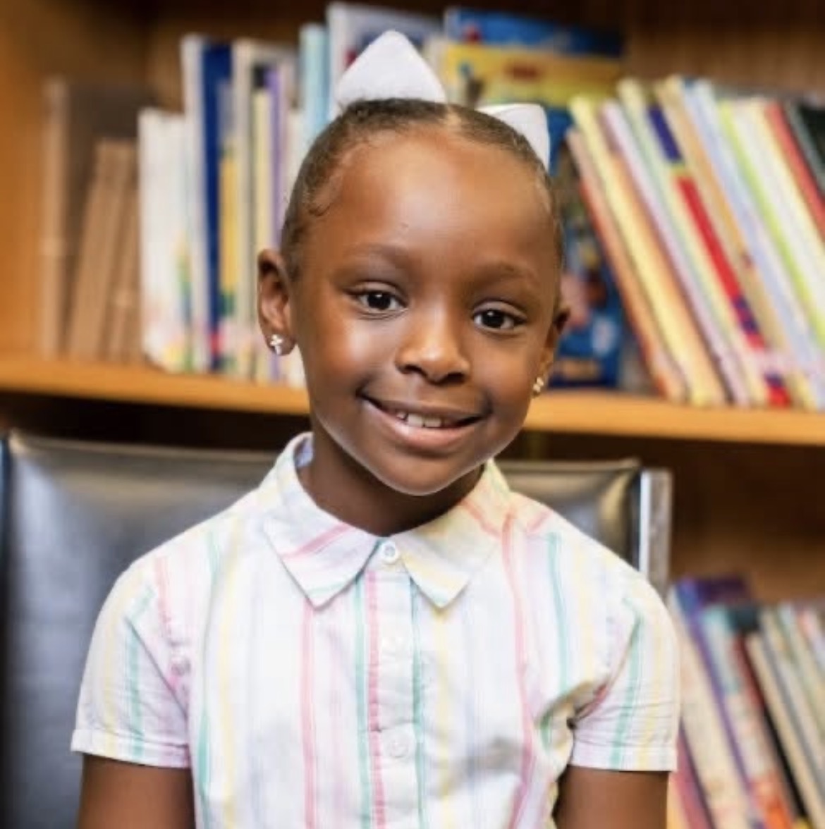 Elaya Davis smiling in a library